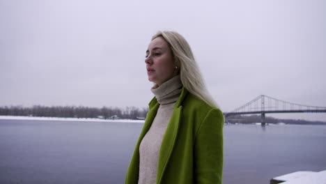 sad woman walking near the lake