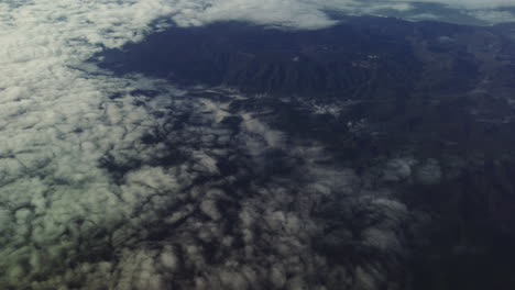 A-cinematic-aerial-view-of-mountains-and-clouds-taken-from-a-plane-over-California's-Santa-Cruz-Mountains