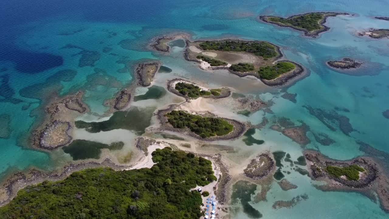 Cinematic high-angle drone panorama of the Lichadonisia islands. Stunning view of turquoise lagoons, volcanic islets and organized beach. The "Seychelles of Greece" in Evia. Ideal for travel films