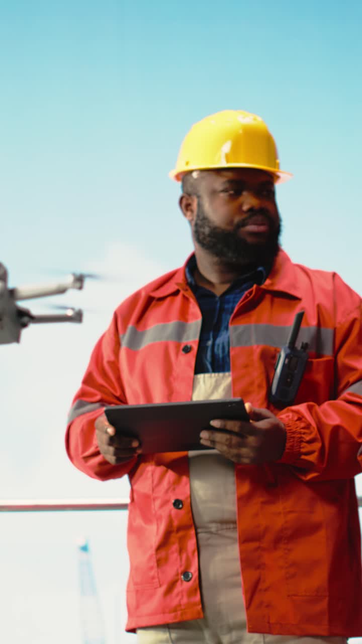 Vertical video Drilling rig engineering team using drone to access dangerous areas