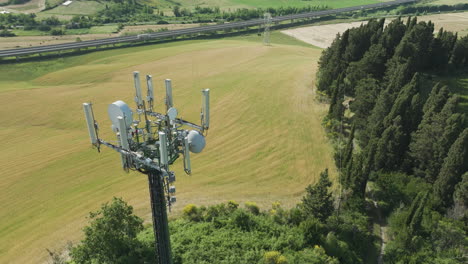 communications tower in lush countryside, italy, aerial view