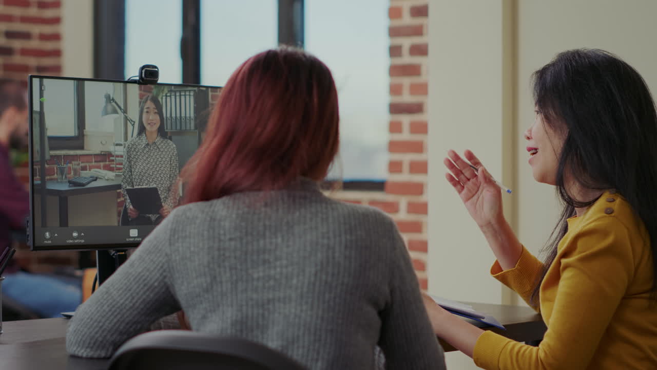 Colleagues using video call to hire woman at job interview