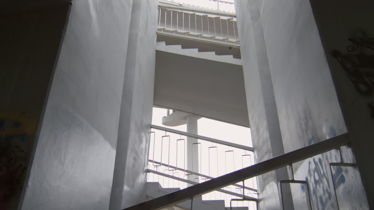 Two Sportsmen Running on Urban Stairs
