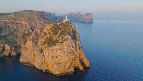 formentor lighthouse on top of tramuntana mountain seen from afar