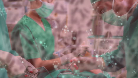 animation of covid 19 cells over diverse surgeons wearing face masks in operating theatre