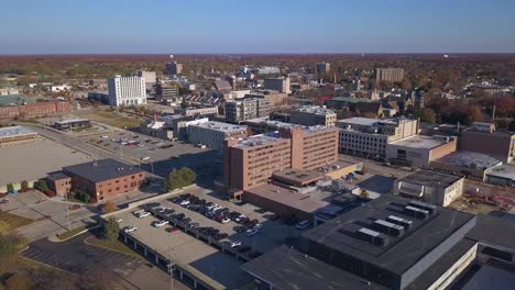 wide aerial of trafficked streets in muskegon, mi, backward motion