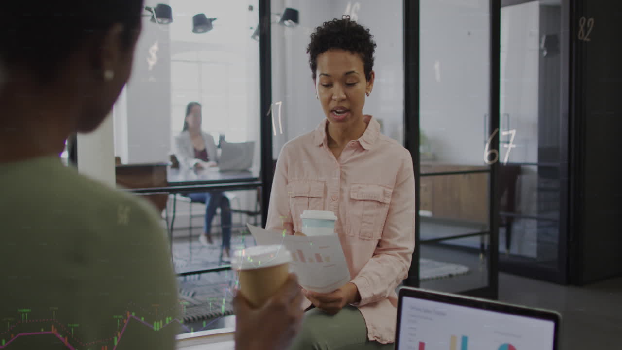 Animation of numbers and symbols over diverse business people at office