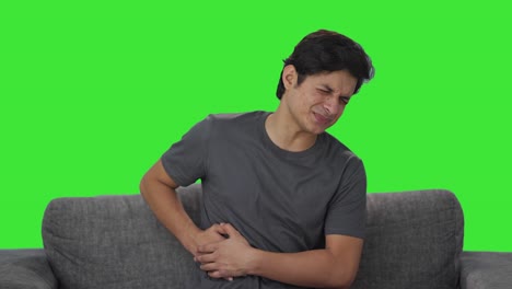 sick indian man suffering from stomach pain green screen
