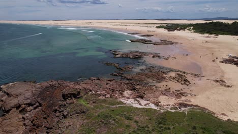 birubi beach with tourists in new south wales, australia - aerial drone shot