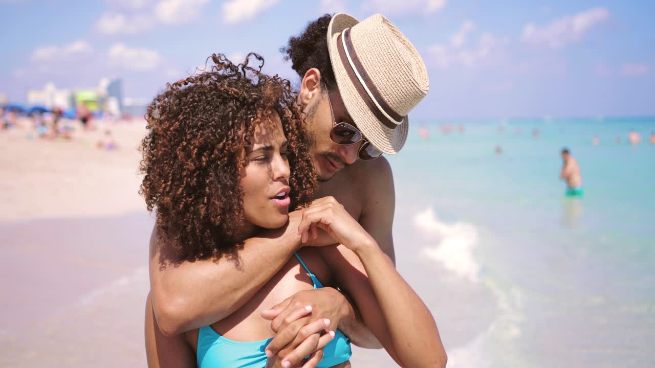 Embracing couple looking at ocean