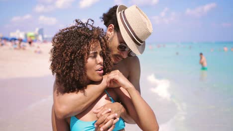 embracing couple looking at ocean