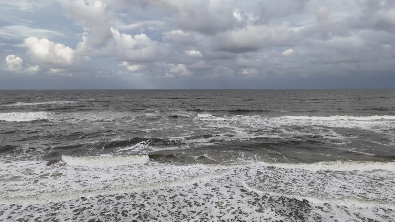 Rough ocean waves under cloudy skies at Gold Coast, Australia. Dynamic movement and turbulent waters create a dramatic atmosphere
