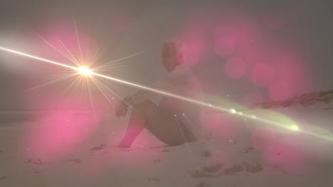 Senior man kneeling on sandy beach at sunrise, showing health theme with animated sun icon
