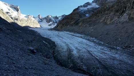 Aerial-flyover-alongside-Forno-glacier-in-Engadin,-Switzerland-shortly-before-sunset