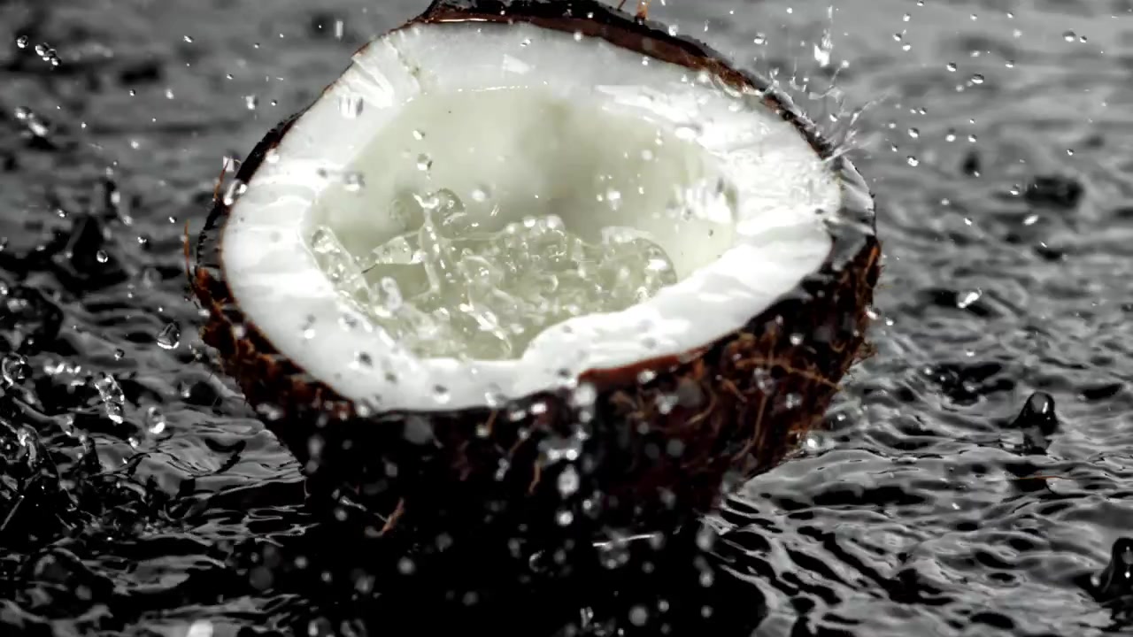 Slow Motion Water Splashing on a Half Coconut