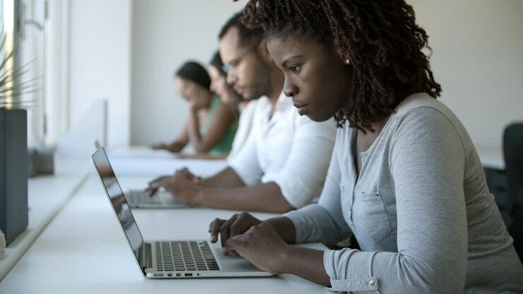 Slow motion shot of focused young woman using laptop
