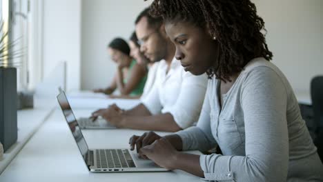 Slow-motion-shot-of-focused-young-woman-using-laptop