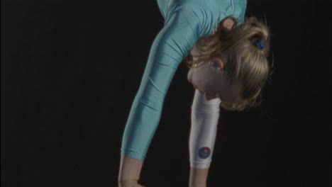 young gymnast performing on a balance beam