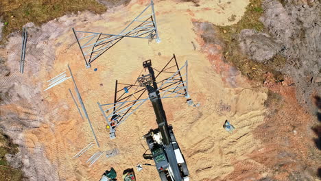 construction of a electrical transmission tower pylon - orbiting aerial view