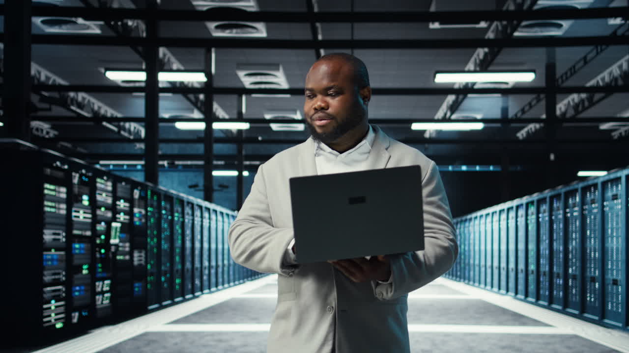 Vertical video Engineer walking in server room backing up storage arrays using software