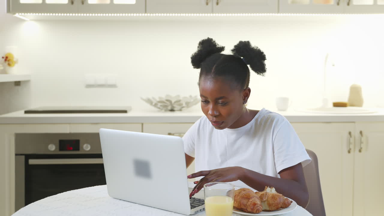 Young Woman Working on Laptop During Breakfast