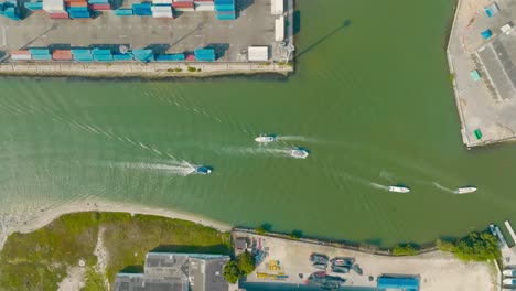 Aerial-top-down-Drone-shot-of-boats-Passing-the-port,-Colombia-Cartagena