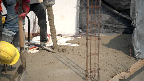movimiento lento de mezcla de hormigón fresco que se bombea a la red en un sitio de construcción en méxico para crear la losa de la casa