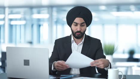 serious sikh indian businessman talking to employees