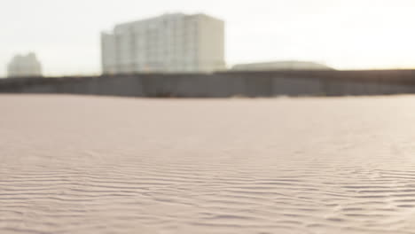 empty construction site with sandy ground in front of buildings