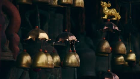 Hanging-brass-wind-chimes-or-feng-shui-bells-believed-to-bring-luck-and-wellness-in-the-home