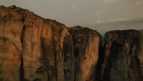 glowing precipitous columns of rock at golden hour - meteora, greece