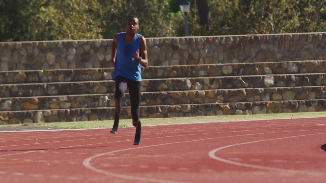 Disabled mixed race man with prosthetic legs running on race track