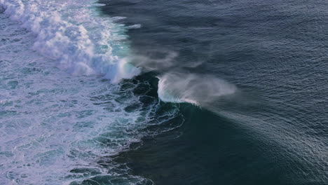 wide aerial of famous one eye sea wave breaking by le morne, mauritius