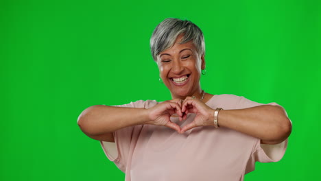 Heart,-hands-and-senior-woman-on-green-screen