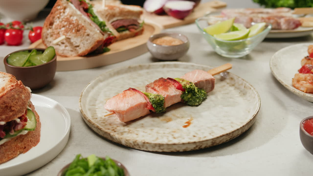 Hands Preparing Salmon Skewers with Side Dishes