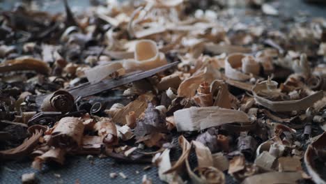 pan of wood shavings on floor of workshop