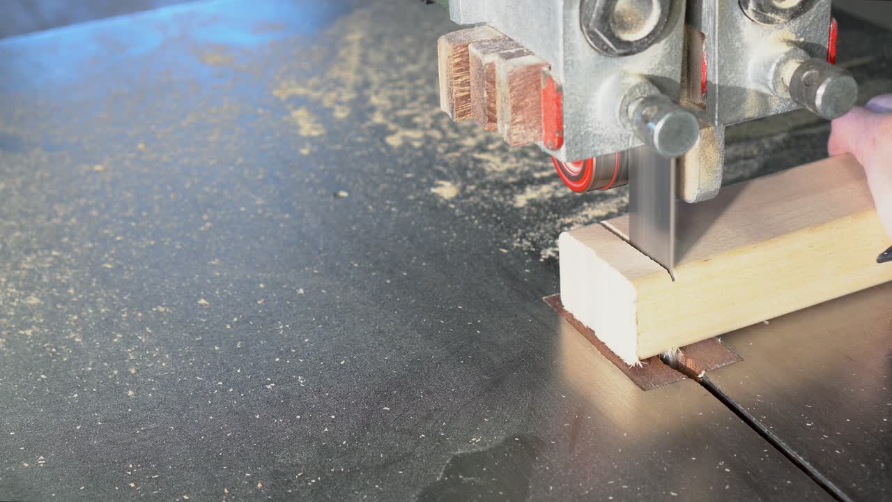 Close-up of a Band Saw Cutting Wood in a Workshop
