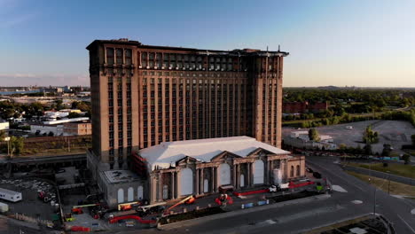 drone sweeping footage of michigan central station in detroit at sunset