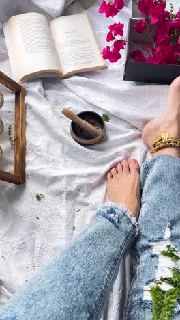 woman relaxing with book and jewelry