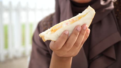 child eating a sandwich