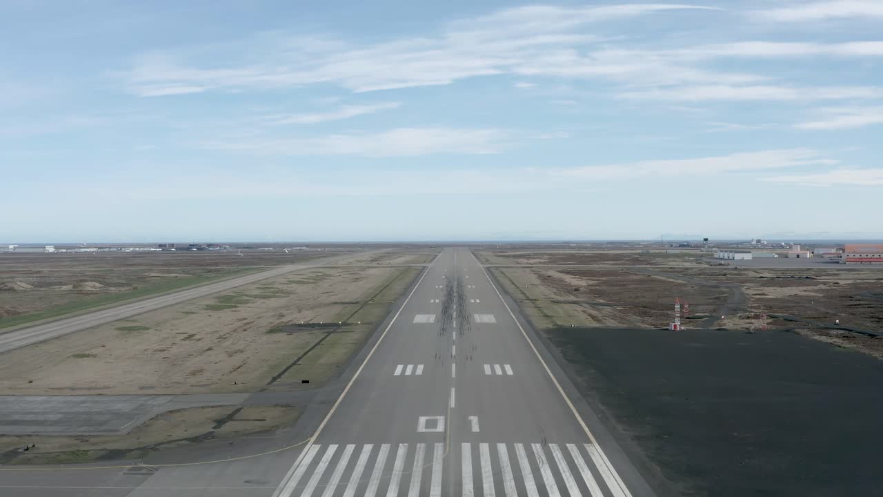 Aerial of Reykjavik runway on clear day with no air traffic and distant horizon
