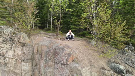 Sunrise-light-at-Palisade-head,-lake-superior-minnesota,-aerial-footage,-traveller-seated