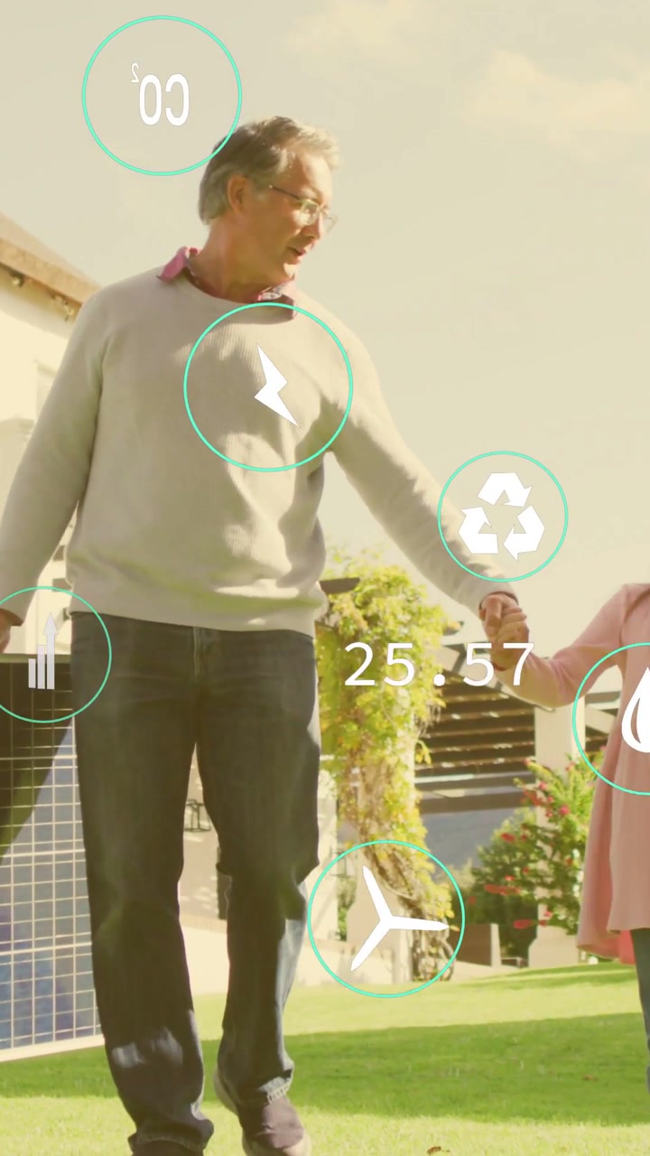 Video vertical: Hombre sosteniendo un panel solar guiando a una niña por el césped con métricas de energía animadas superpuestas.