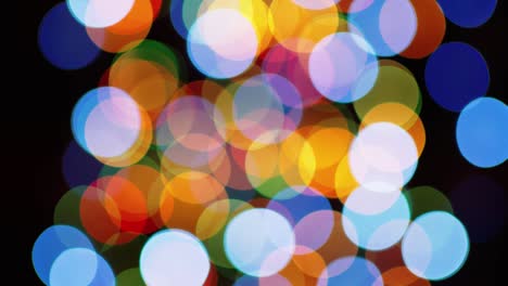 multicolored blinking bokeh on a black background.