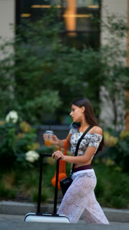 woman walking with a suitcase in the city