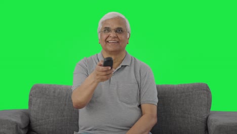 Happy-Indian-old-man-watching-TV-Green-screen