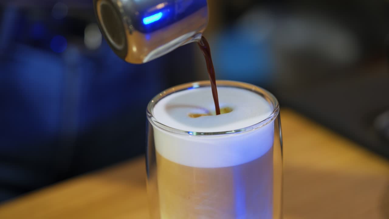 Barista brewing coffee by modern machine. Female barista in uniform making coffee in bar
