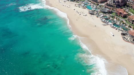 Beautiful-blue-sea,-waves-and-beach-in-sunny-holiday,-drone-view