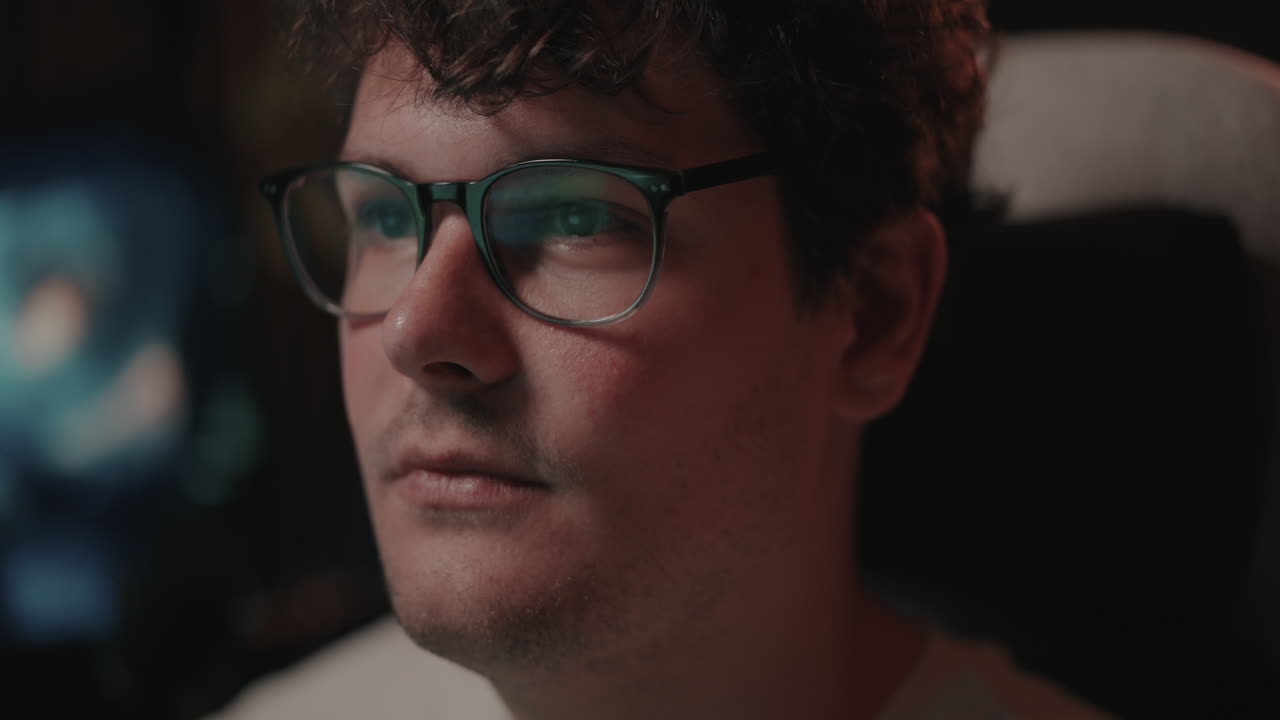 Close-up of a man wearing glasses, looking attentively