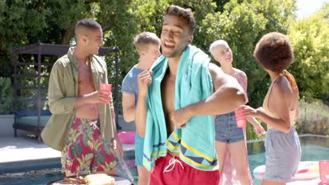 Portrait-of-happy-diverse-group-of-friends-drinking-drinks-and-dancing-at-pool-party-in-summer